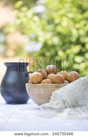 Small Balls Of Freshly Baked Homemade Cottage Cheese Doughnuts In A Plate . Donuts In Powdered Sugar