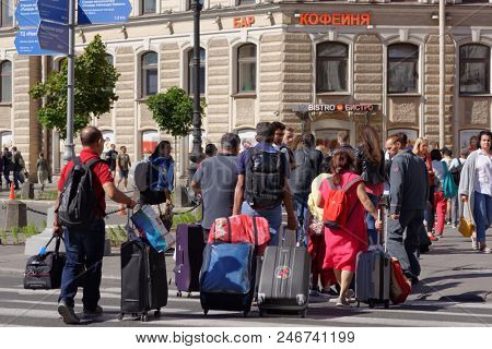 ST. PETERSBURG, RUSSIA - JUNE 20, 2018: Group of Indian football fans at Moskovsky train station of Saint Petersburg during FIFA World Cup Russia 2018. The city hosts 7 matches of FIFA World Cup