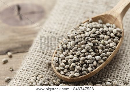 Hemp Seeds In A Rustic Wooden Spoon On The Burlap Napkin, Space For Text