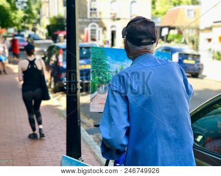 HAMPSTEAD, LONDON - 24 JUNE, 2018: A man painting a street view in Hampstead, London, UK.