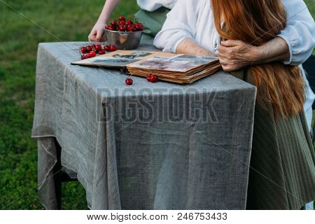 Memories Of The Elderly. Visit Grandmother. Grandmother With Her Grandchildren Sitting In A Chair In