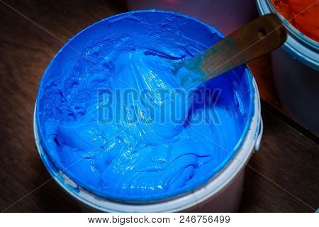 blue color of plastisol ink in white plastic barrel. plastisol ink is specially for print on tee shi