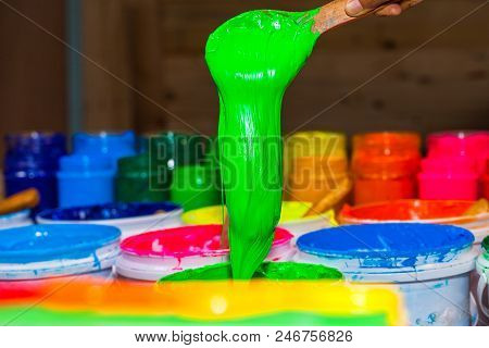 blue color of plastisol ink in white plastic barrel. plastisol ink is specially for print on tee shi