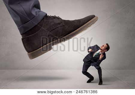 Young businessman illustrated inconsiderable by being trampled