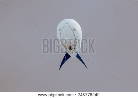 White Airship On A Gray Sky Background .