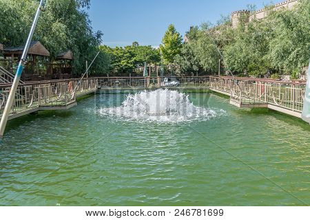 Beautiful Fountain On Water Lake. Green Water.