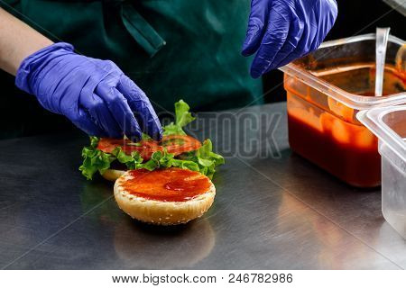 Chef In Sterile Gloves Prepares A Vegetarian Burger Close-up