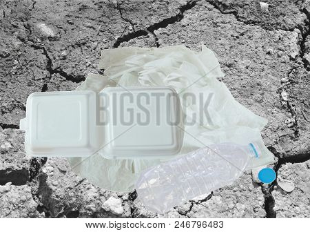Plastic Bag Bottle And Foam Box On Crack Ground Background