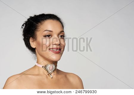 Happy Closeup Portrait Of Beautiful Mixed Race Woman Wearing Chocker Looking Away, Isolated On Gray 