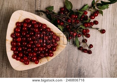 Fresh Red Cherries In A Wooden Plate On A Wooden Table. Wooden Plate On A Wooden Background. Next To