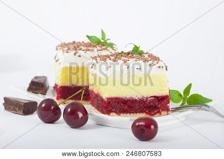 Delicious Homemade Cherry Cake With Vanilla And Whipping Cream. Decorated With Mint Leaves And Chunk