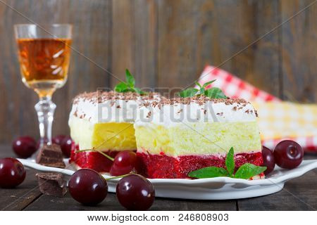 Sweet Homemade Cherry Cake With Vanilla And Whipping Cream. Served With A Glass Of Cherry Brandy. Ru