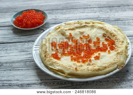 Pancakes With Red Caviar In A White Plate On A Wooden Background. Celebration Of Maslenitsa