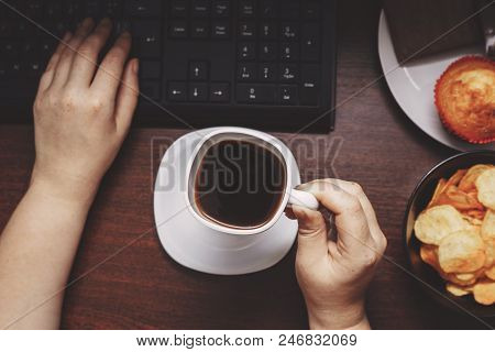 Unhealthy Food, Mindless Snacking, Coffee Break At Work Place, Compulsive Overeating. Woman Drinking