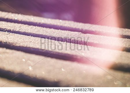 Close Up Of Light Leaks And Wooden Planks Covered With Sparkling Hoar Frost In Free Lensing Techniqu