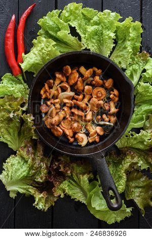 Healthy Tasty Forest Mushrooms. Fried Golden Chanterelle Mushrooms In Cast Iron Pan Served With Lett