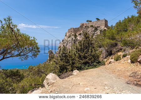 The Castle Of Monolithos Located At The Summit Of The Tall And Craggy Rock. Rhodes Island, Greece