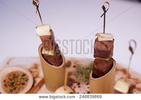 Grilled Pork Meat With Sauce Inserted With Bamboo Sticks. Shallow Dof.