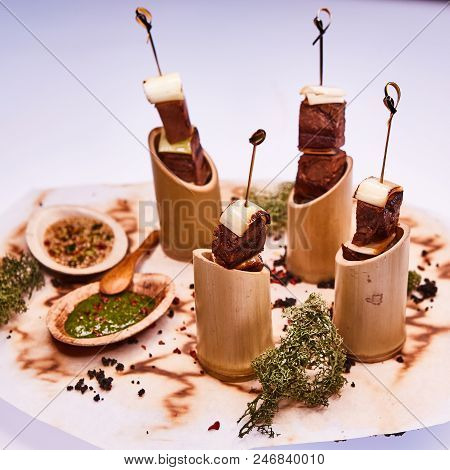 Grilled Pork Meat With Sauce Inserted With Bamboo Sticks. Shallow Dof.