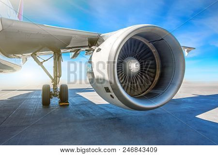 Wing Jet Engine Of The Aircraft In The Parking Lot At The Airport Apron On A Sunny Day