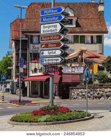 Schwyz, Switzerland - June 23, 2018: A Directional Sign And Buildings In The Historic Part Of The To