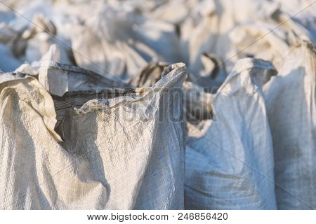 Group Of Filled Plastic Woven Sacks, Packing Of Goods For Transportation And Storage In A Warehouse,