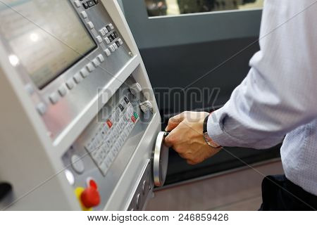 Cnc Machine Operator Making Adjustments With The Control Panel. Selective Focus.