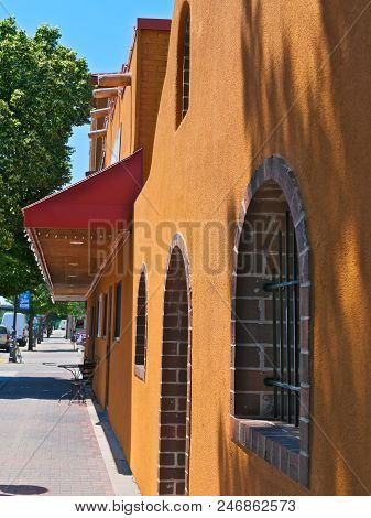 Orange Stucco Storefront In And Sidewalk In Bemidji Minnesota On A Sunny Day