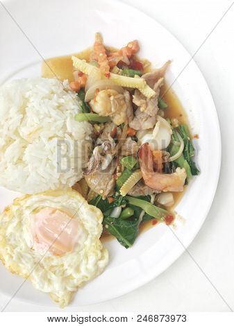 Vegetable Stir-fry Dishes With Spicy  Seafood With Basil Leaves And Mixed Vegetable And Fried Egg On
