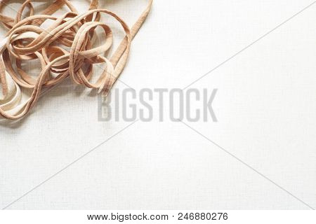 Top View Of Untangled Tangle On The White Desk. Sunny Day. Flat Lay With Copy Space For Text.
