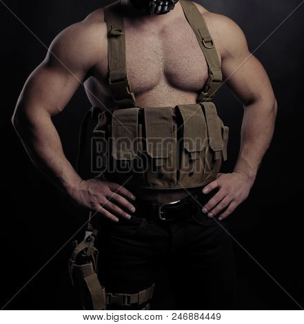 Stong military man torso on dark studio background