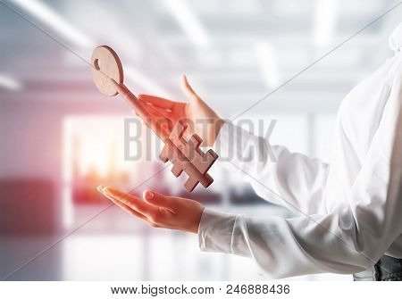 Business Woman In White Shirt Keeping Big Stone Key In Hands With Office View And Sunlight On Backgr
