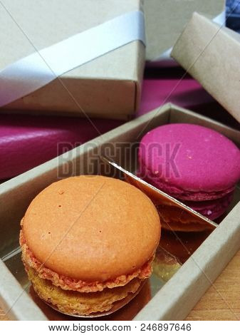 Orange And Pink Macarons In The Box.