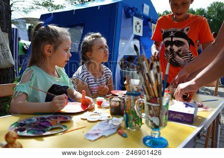 Russia, Koltsovo - June 23, 2018: Russian children at master class at open air art studio during celebrating the International Festival of National Cultures in small science city Koltsovo in Siberia