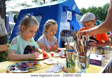 Russia, Koltsovo - June 23, 2018: Russian children at master class at open air art studio during celebrating the International Festival of National Cultures in small science city Koltsovo in Siberia