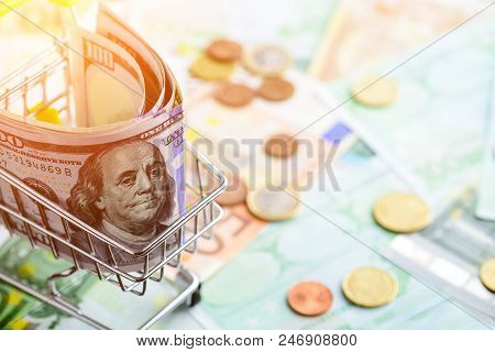 One Hundred Dollar Bills In The Shopping Cart In Rays Of The Sun. Concept Of Necessary Expenditure A