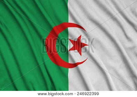 Algeria Flag  Is Depicted On A Sports Cloth Fabric With Many Folds. Sport Team Waving Banner