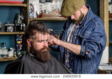 Hipster Lifestyle Concept. Hipster Client Getting Haircut. Barber With Hair Clipper Work On Hairstyl