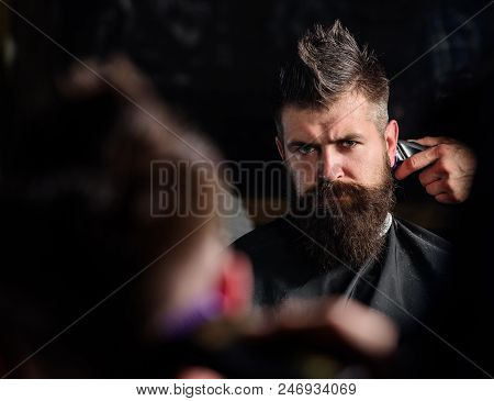 Reflexion Of Barbers Hand With Hair Clipper Trimming Nape Of Client. Hipster Bearded Client Getting 