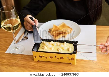 Swiss Food. Cheese Raclette With Mushrooms On Coupelles - Special Small Skillet For A Raclette