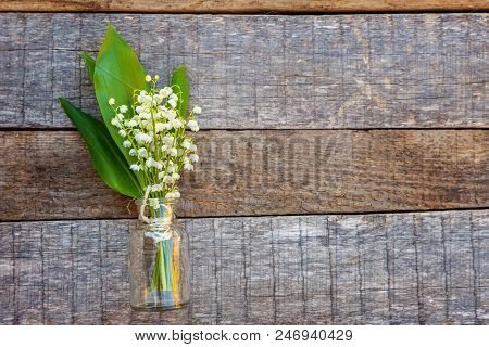 Bouquet Of Flowers Beautiful Smell Lily Of The Valley Or May-lily In Glass Vase On Rustic Old Vintag