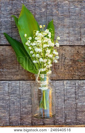Bouquet Of Flowers Beautiful Smell Lily Of The Valley Or May-lily In Glass Vase On Rustic Old Vintag
