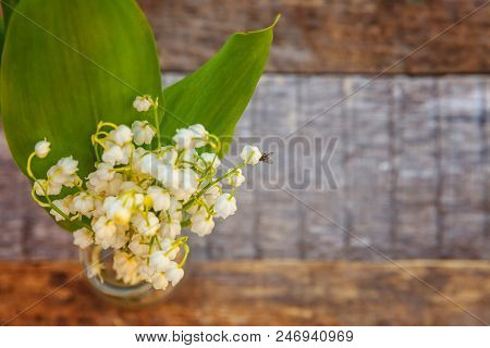 Bouquet Of Flowers Beautiful Smell Lily Of The Valley Or May-lily In Glass Vase On Rustic Old Vintag