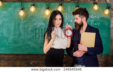 Lady Teacher And Strict Schoolmaster Care About Discipline And Rules In School. Man With Beard Hold 