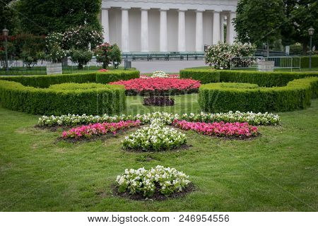 Flowerbed With Various Flowers, Hedges And Green Meadow In Volksgarten, Vienna (austria), Temple In 