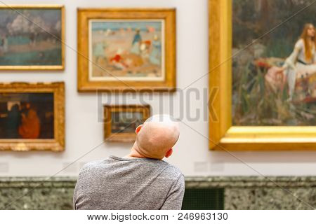 London, Uk - August 15, 2017 - Back View Of A Bald Man Admiring Paintings Displayed At Tate Britain