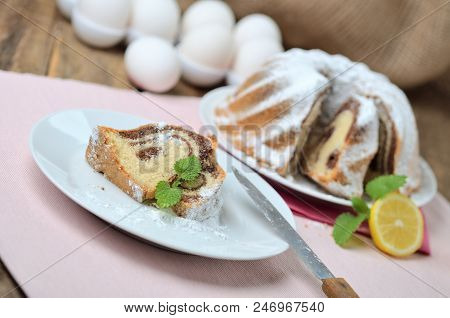 Cut Of Bundt Cake Sprinkled With Sugar, Milk, Eggs, Melissa Leaves, , Still Life With Marble Cake On