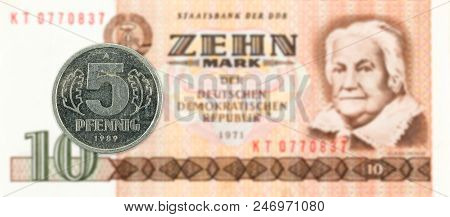5 Pfennig Coin Against Historic 10 East German Mark Bank Note