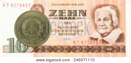 5 Mark Coin Against Historic 10 East German Mark Bank Note