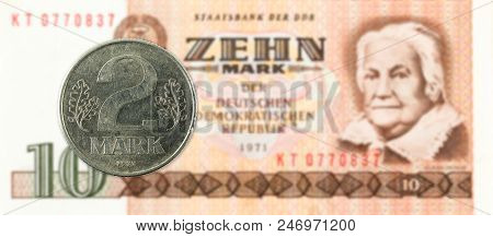 2 Mark Coin Against Historic 10 East German Mark Bank Note